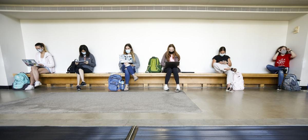 Students wear masks inside of the Mosse Humanities Building as they await their next classes on the first day of the fall semester at University of Wisconsin-Madison. RUTHIE HAUGE
