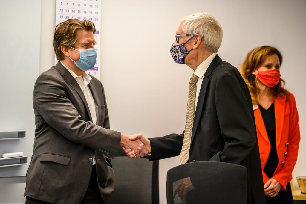 Aaron Olver (left), University Research Park managing director, greets Wisconsin Gov. Tony Evers. Photo by: Althea Dotzour