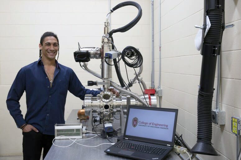 Graduate student Luis Izet Escano with the apparatus he developed to study the structure of metal parts manufactured with a cutting-edge 3D printing process. PHOTO COURTESY IZET ESCANO
