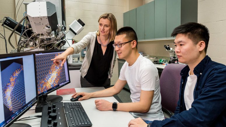 Professor Izabela Szlufarska (standing), and graduate students Xuanxin Hu (middle) and Nuohao Liu (right) have developed new criteria for determining whether shear bands are beneficial or harmful to certain crystalline materials. University of Wisconsin–Madison