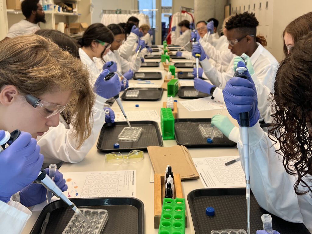 Students practice their pipetting skills with a stem cell activity at the Discovery Building.