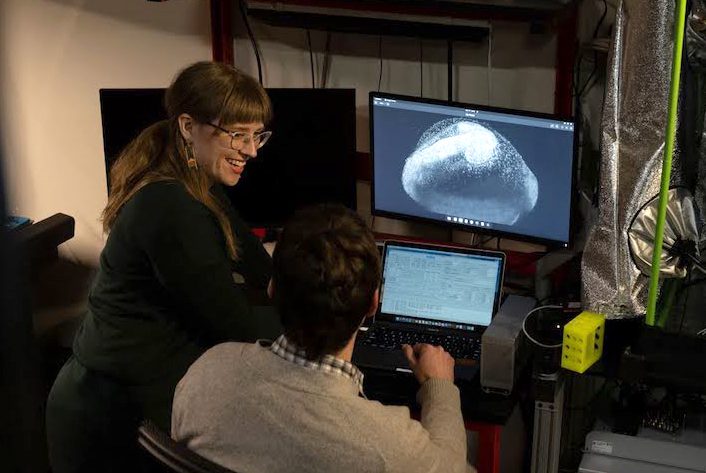 Morgridge Postdoctoral Fellow Liz Haynes discusses zebrafish embryo imaging with a collaborator in the FabLab.