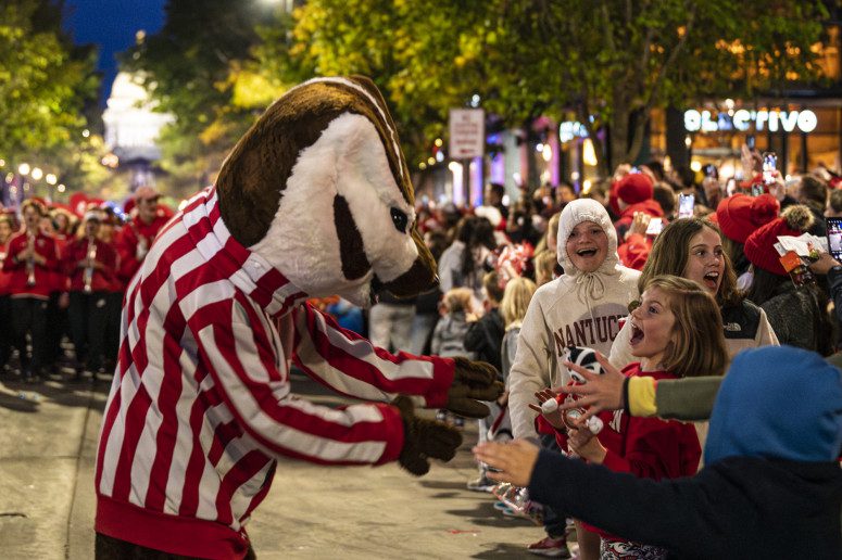 Bucky Badger says hello to some excited parade attendees. PHOTO BY: MK DENTON